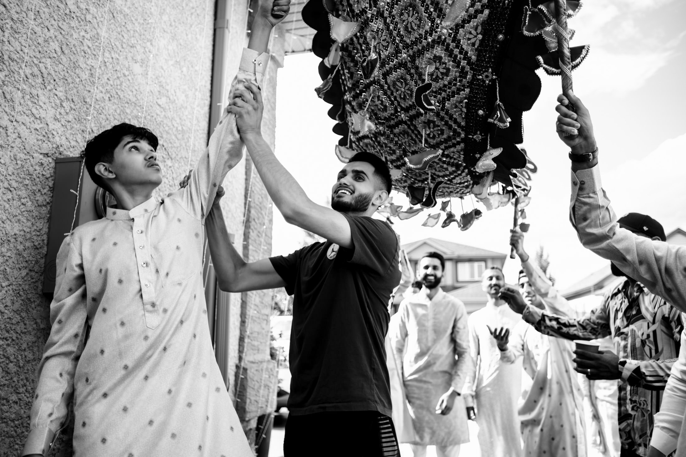 People raising a decorative canopy at a Winnipeg wedding, black and white photo.