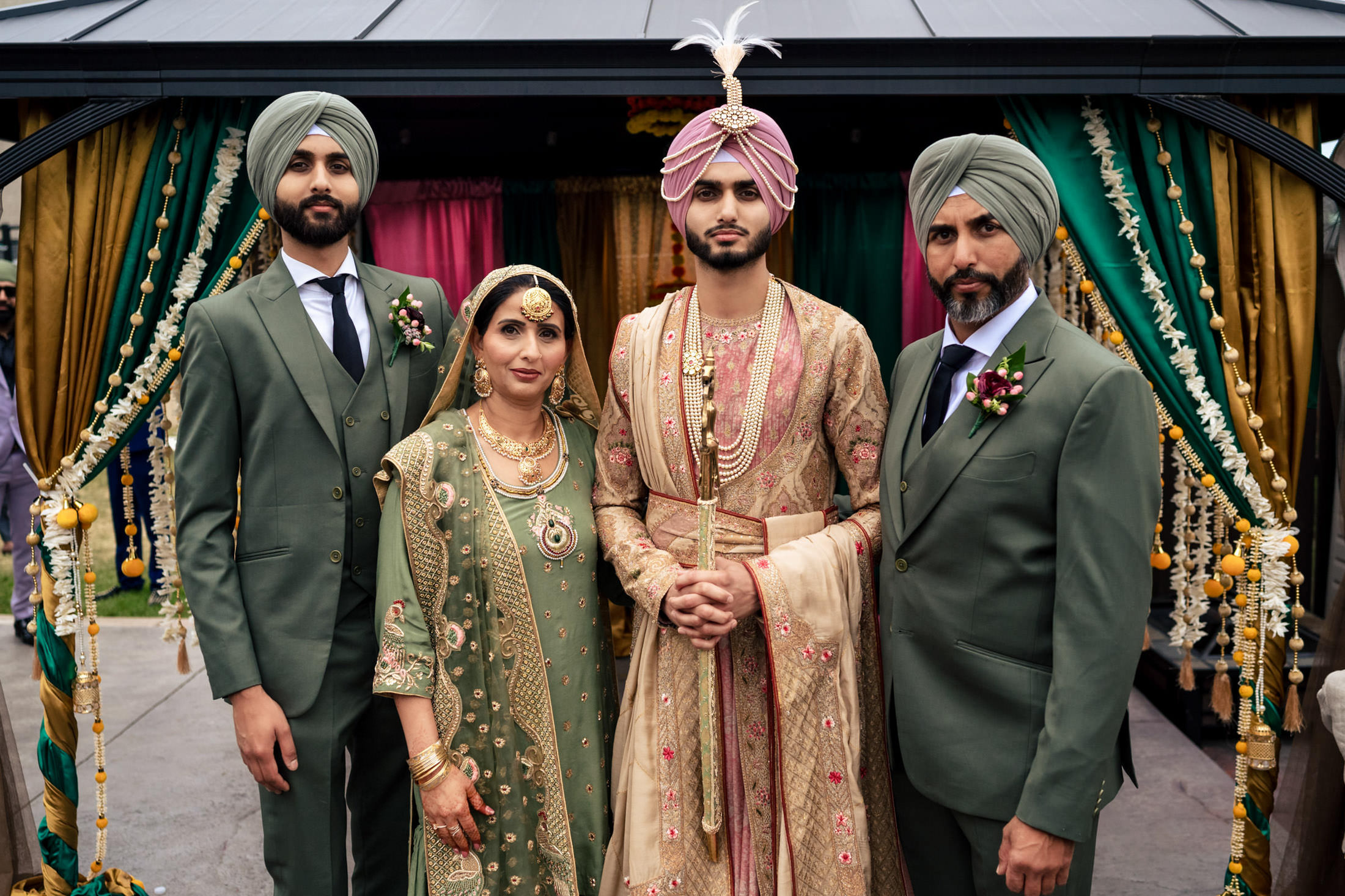 A family in traditional attire poses at a festive Winnipeg wedding.