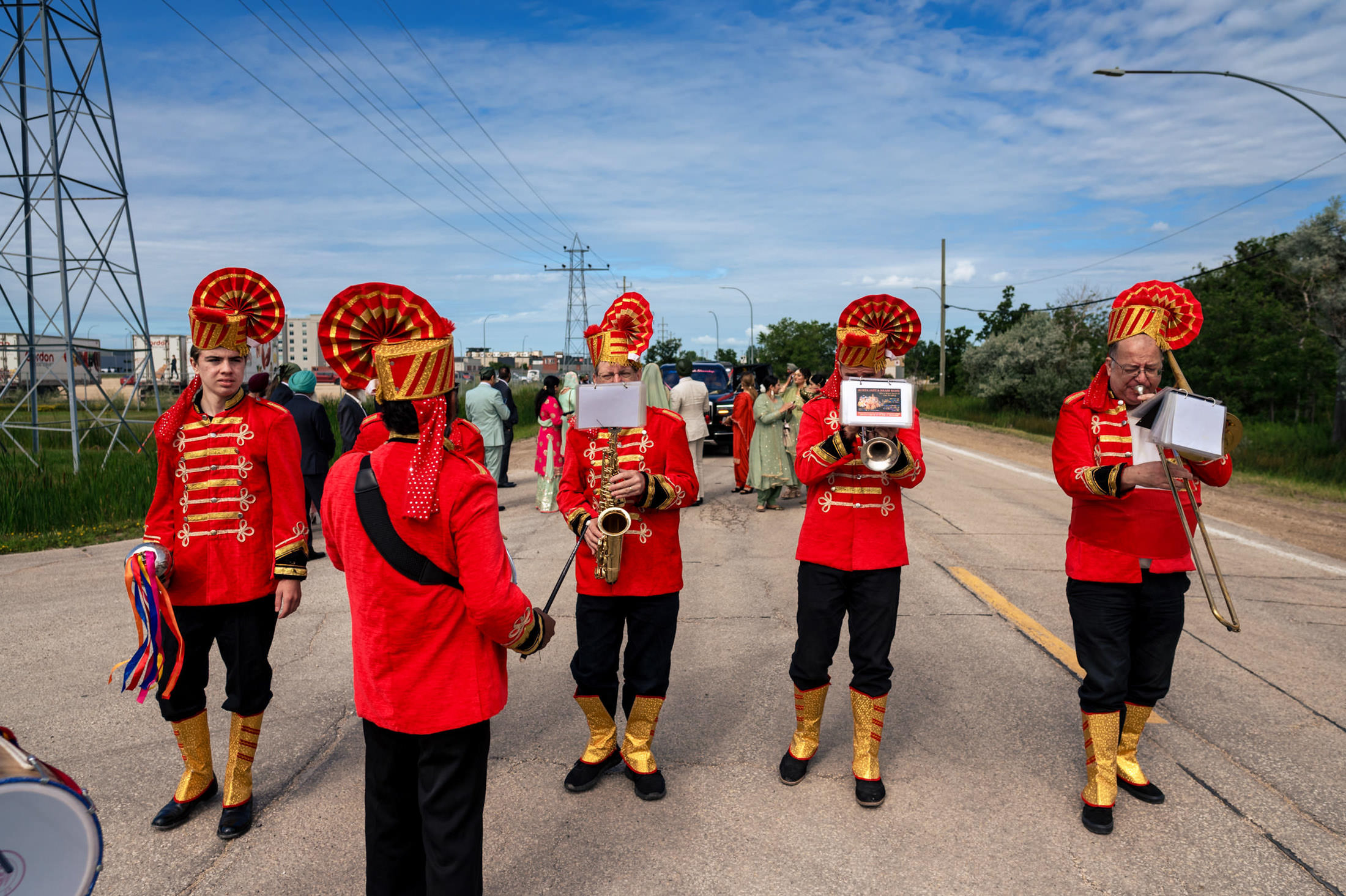 Winnipeg wedding features a marching band in red uniforms playing on the street.