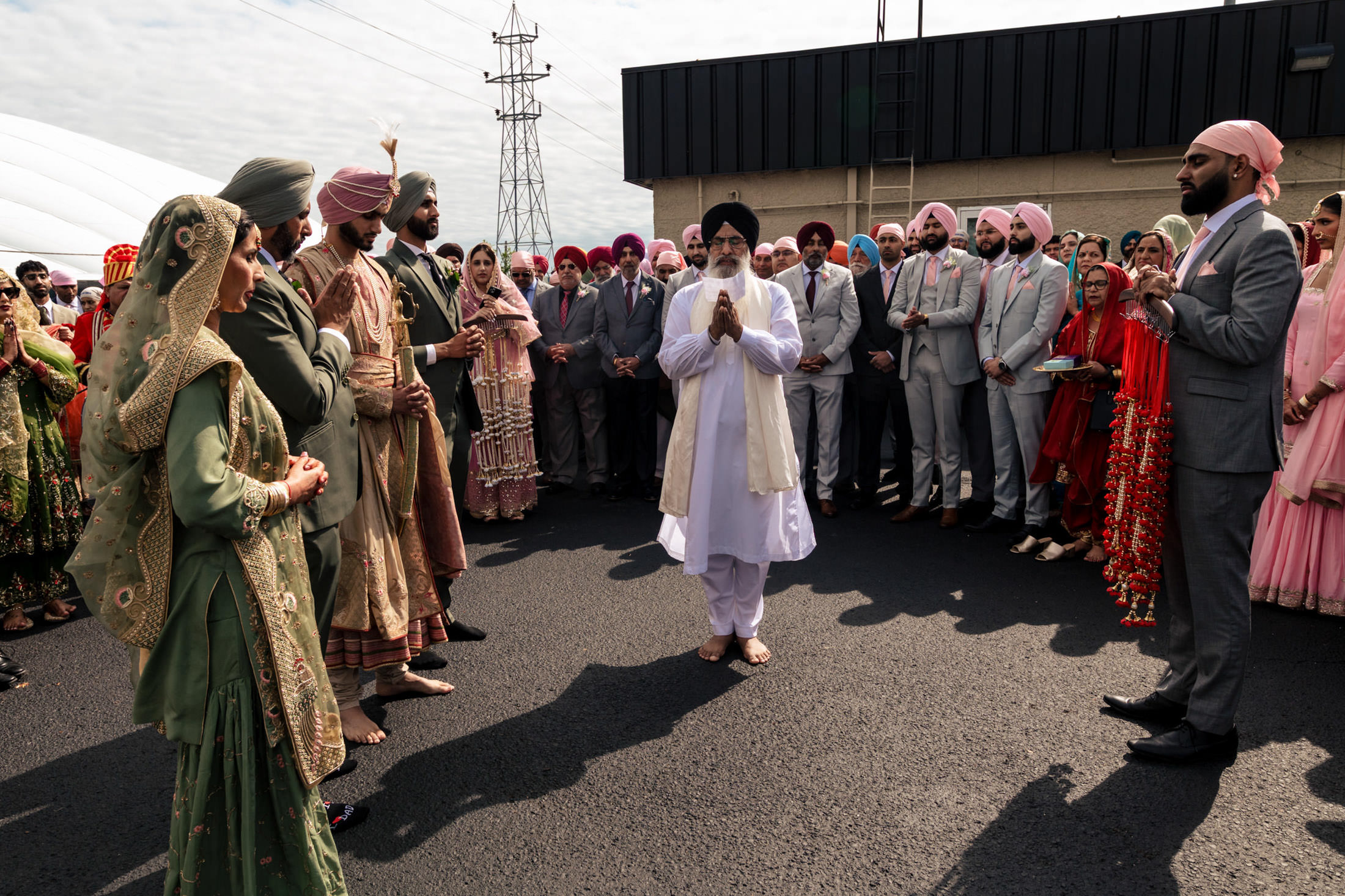 A group in traditional attire gathered outdoors for a Winnipeg wedding celebration.