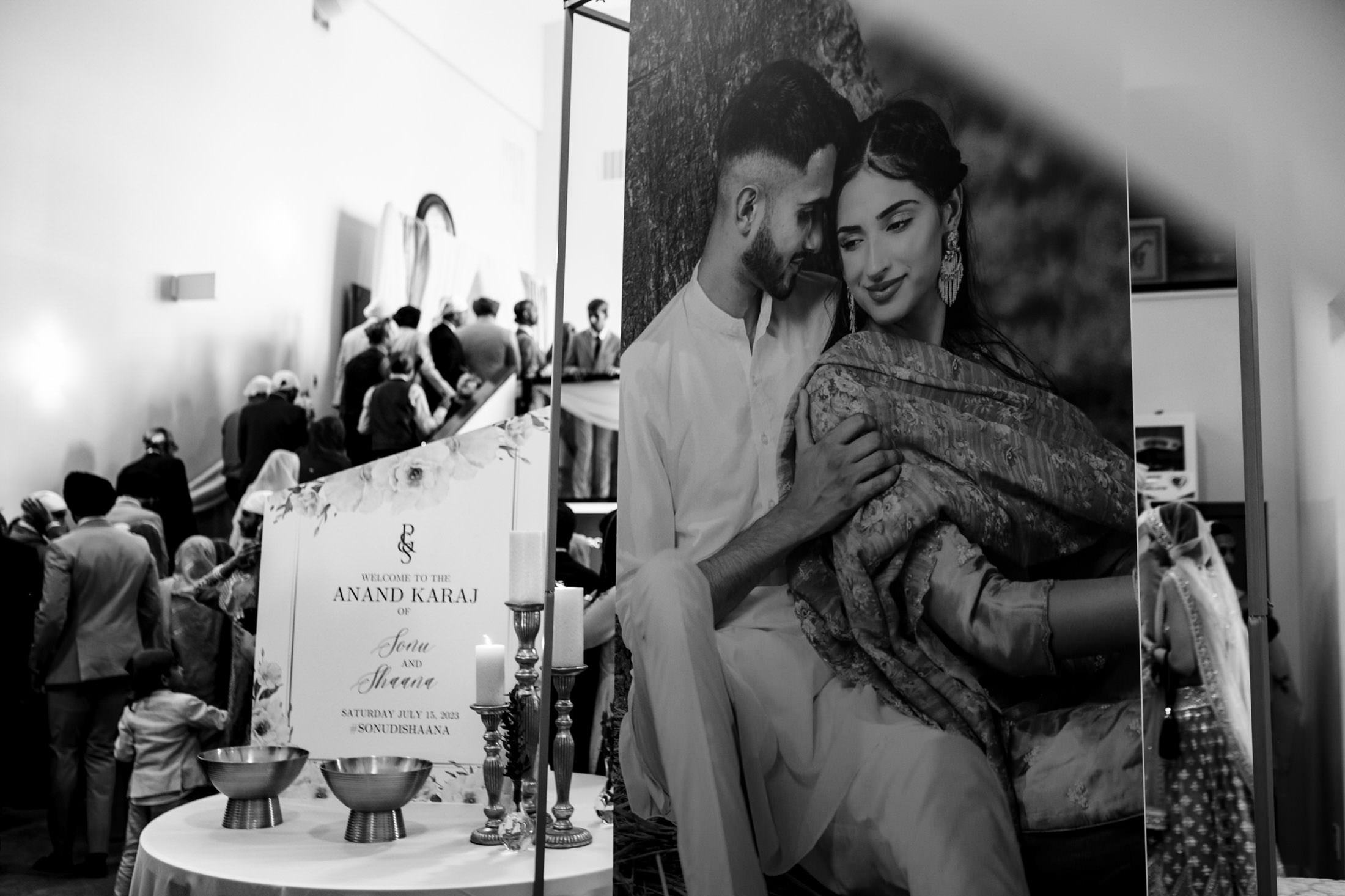Black and white photo: Winnipeg wedding display with couple's portrait and welcome sign.