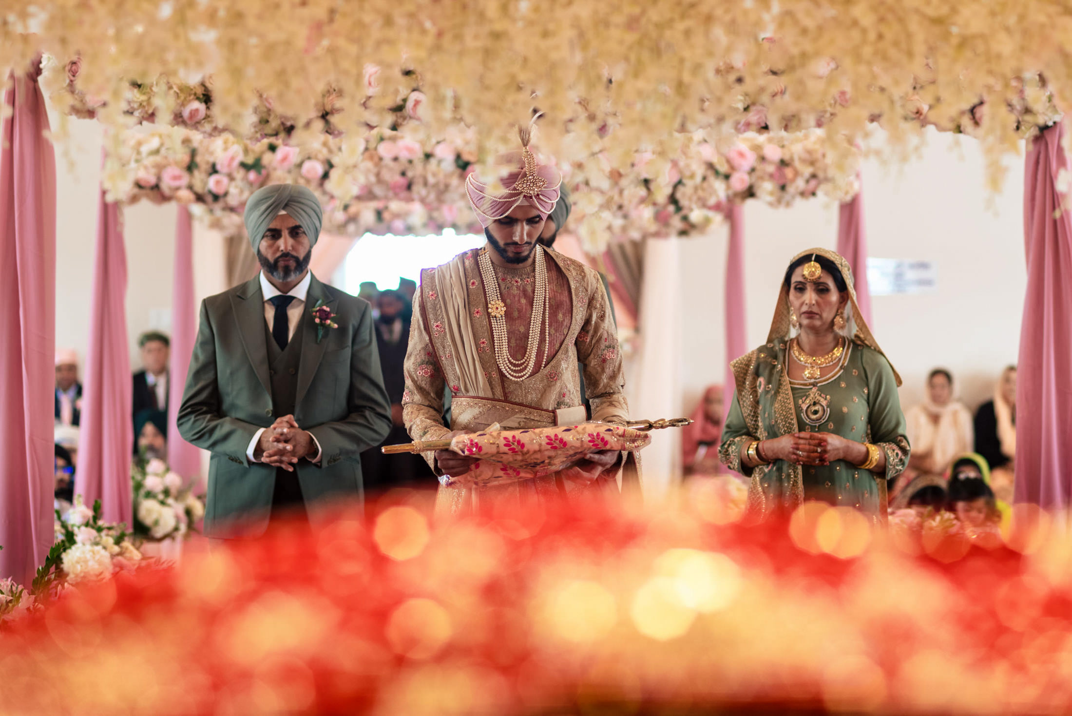 People stand under a floral canopy at a traditional Winnipeg wedding ceremony.
