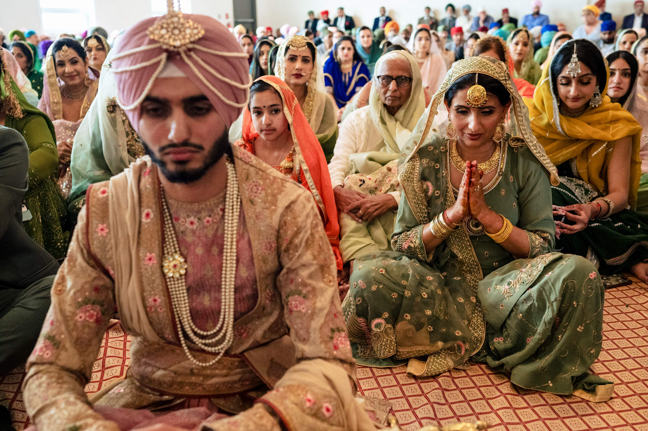 A traditional Winnipeg wedding with a bride, groom, and guests in colorful attire.