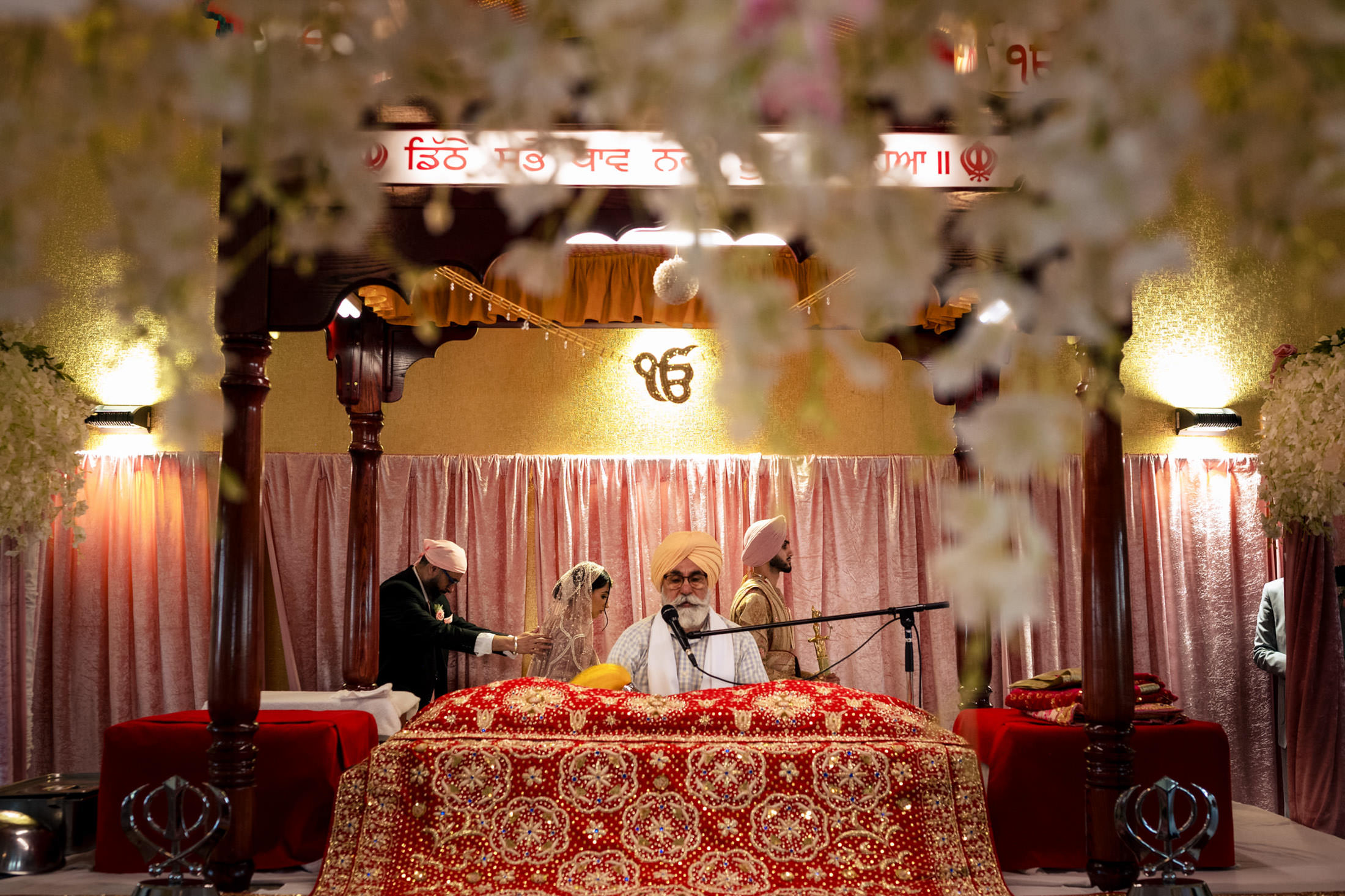 Winnipeg wedding with a couple and priest in a beautifully decorated temple setting.