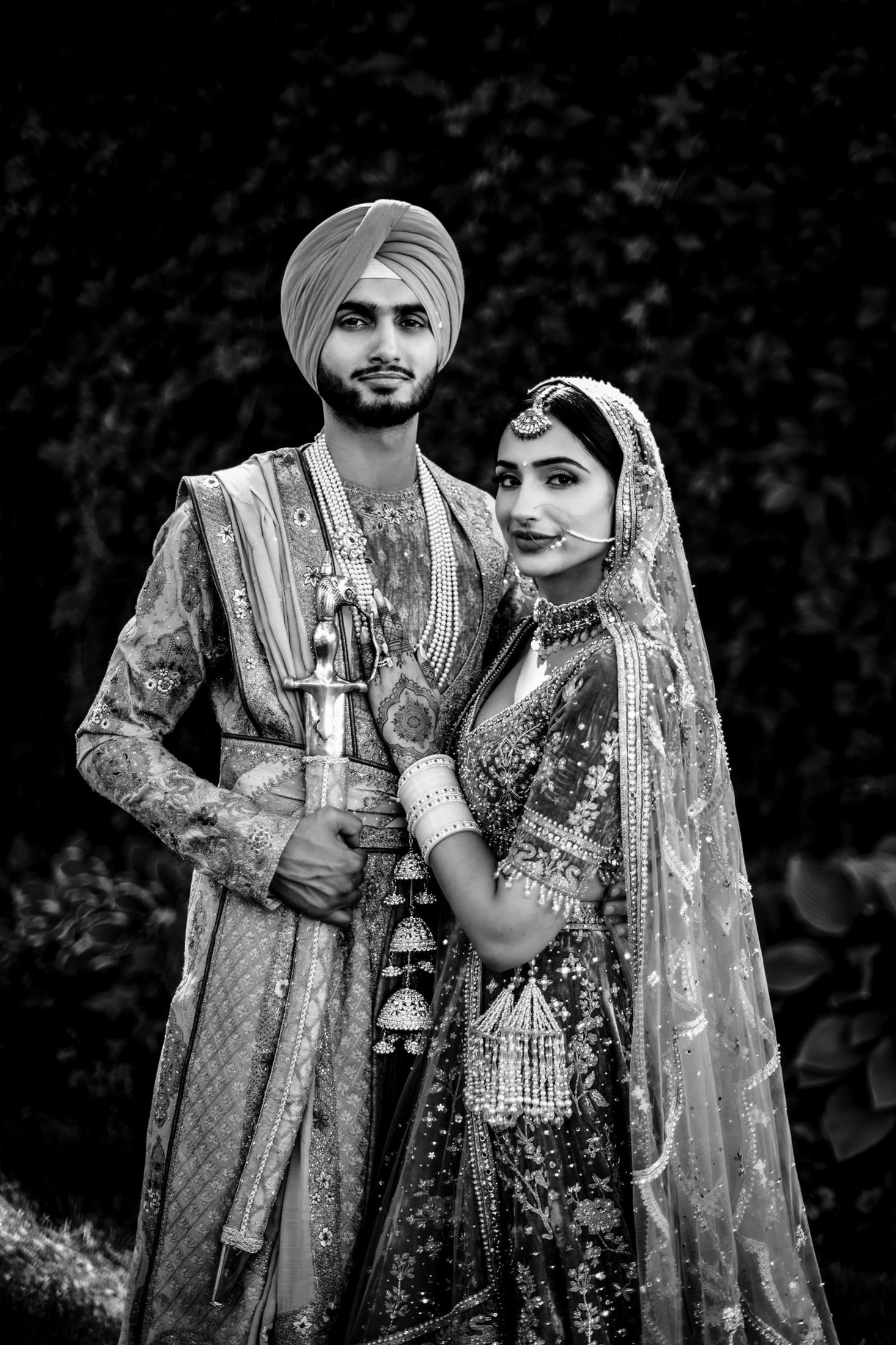 A couple in traditional Indian wedding attire, celebrating outdoors in Winnipeg.
