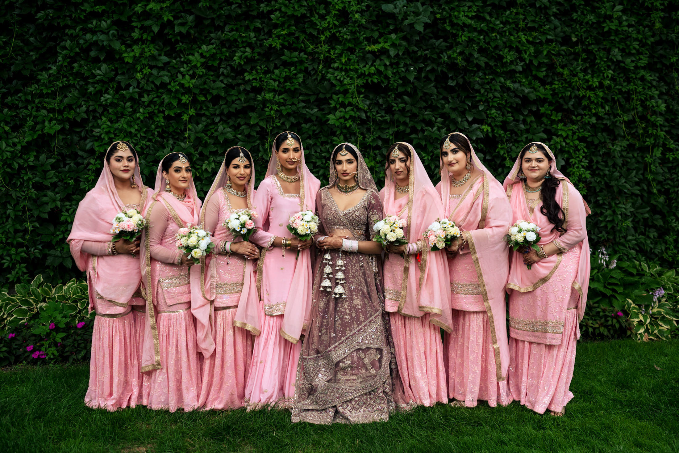 Bride in purple gown and bridesmaids in pink dresses at a Winnipeg wedding.