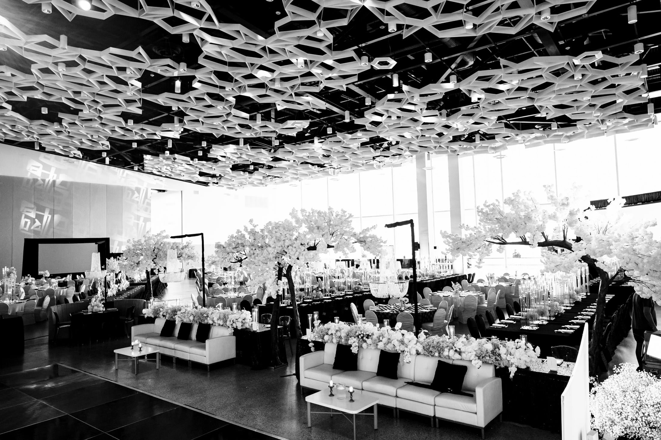 Elegant Winnipeg wedding venue with intricate ceilings and flower-decorated tables.