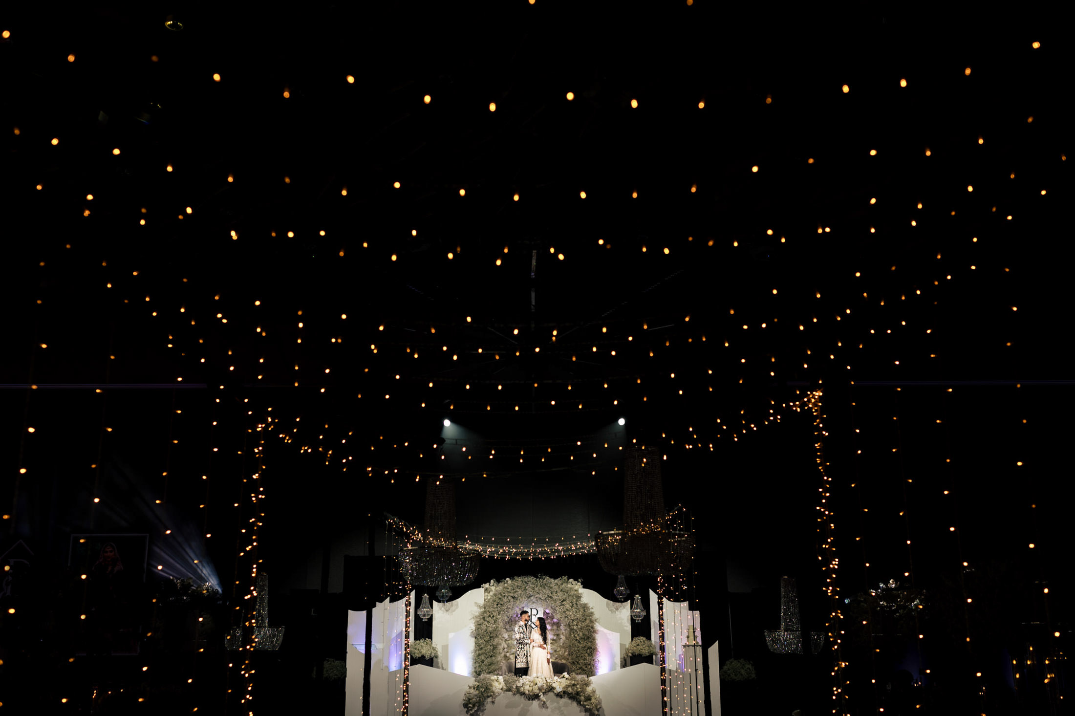 A dreamy Winnipeg wedding aisle adorned with twinkling lights and floral decorations.