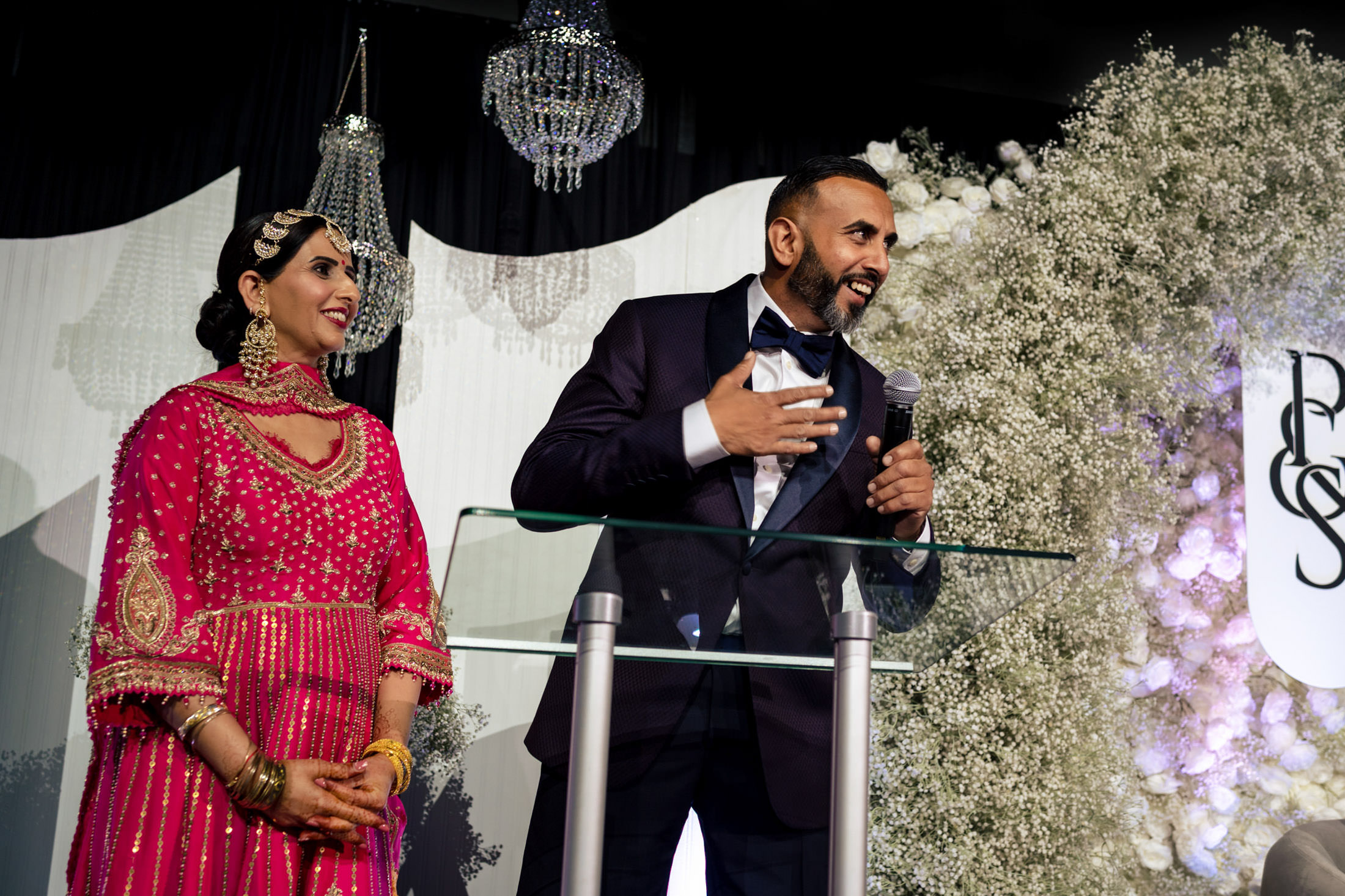 Two people in formal attire speaking at a beautifully decorated Winnipeg wedding.