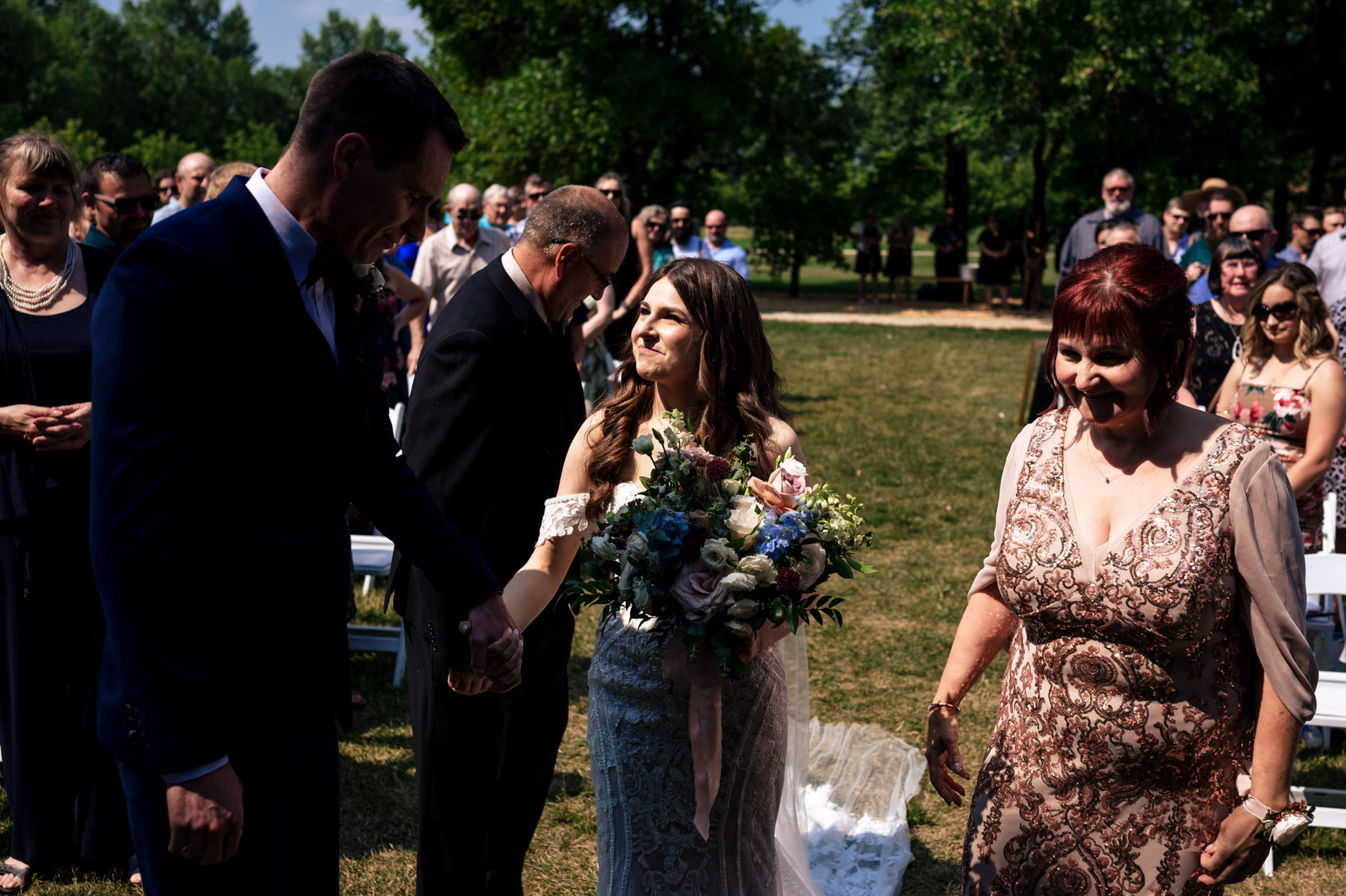 Bride and groom beaming at Ashgrove Acres Wedding, surrounded by joyful guests.