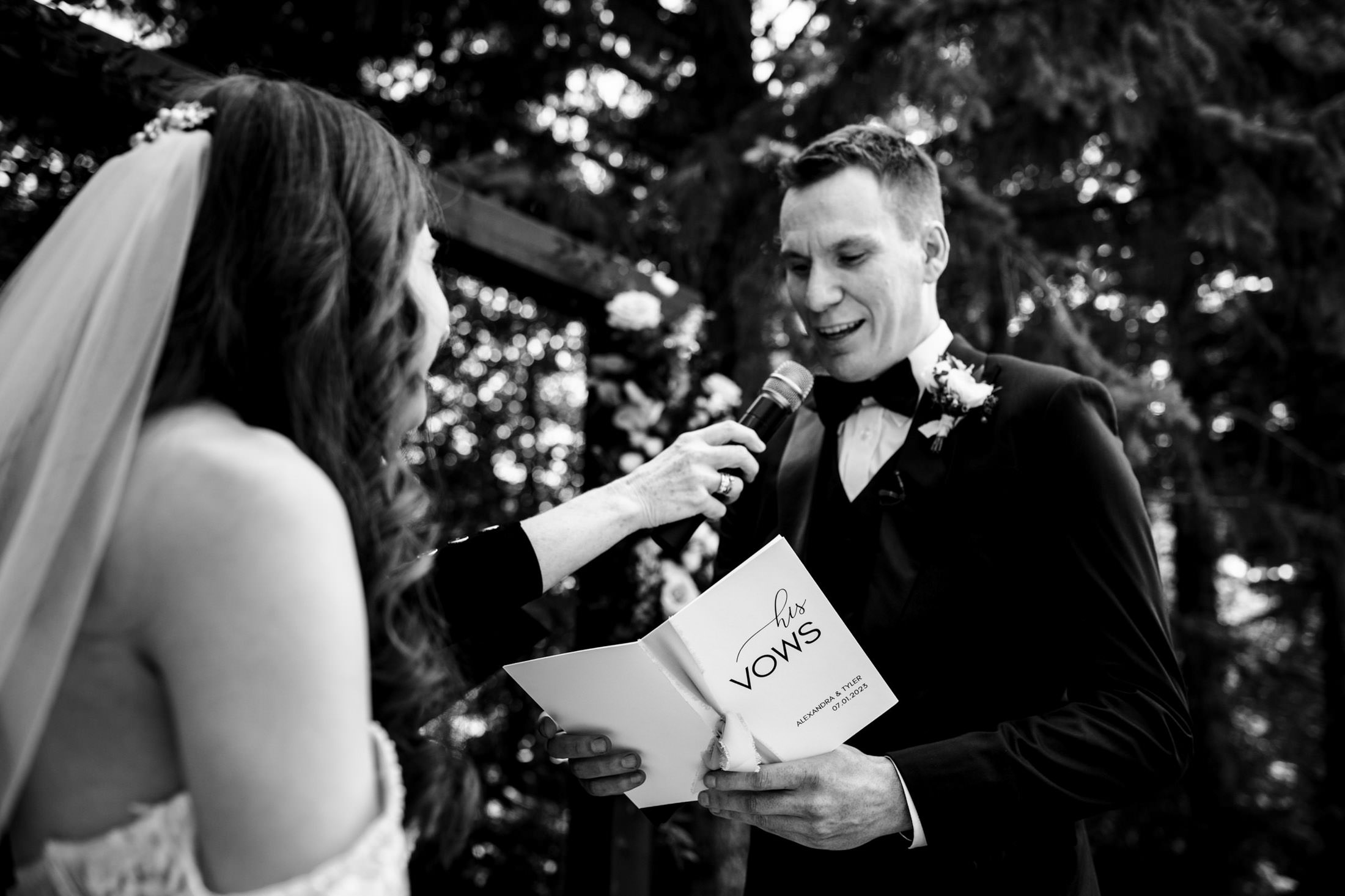At Ashgrove Acres, a groom reads vows to the bride with a microphone in hand.