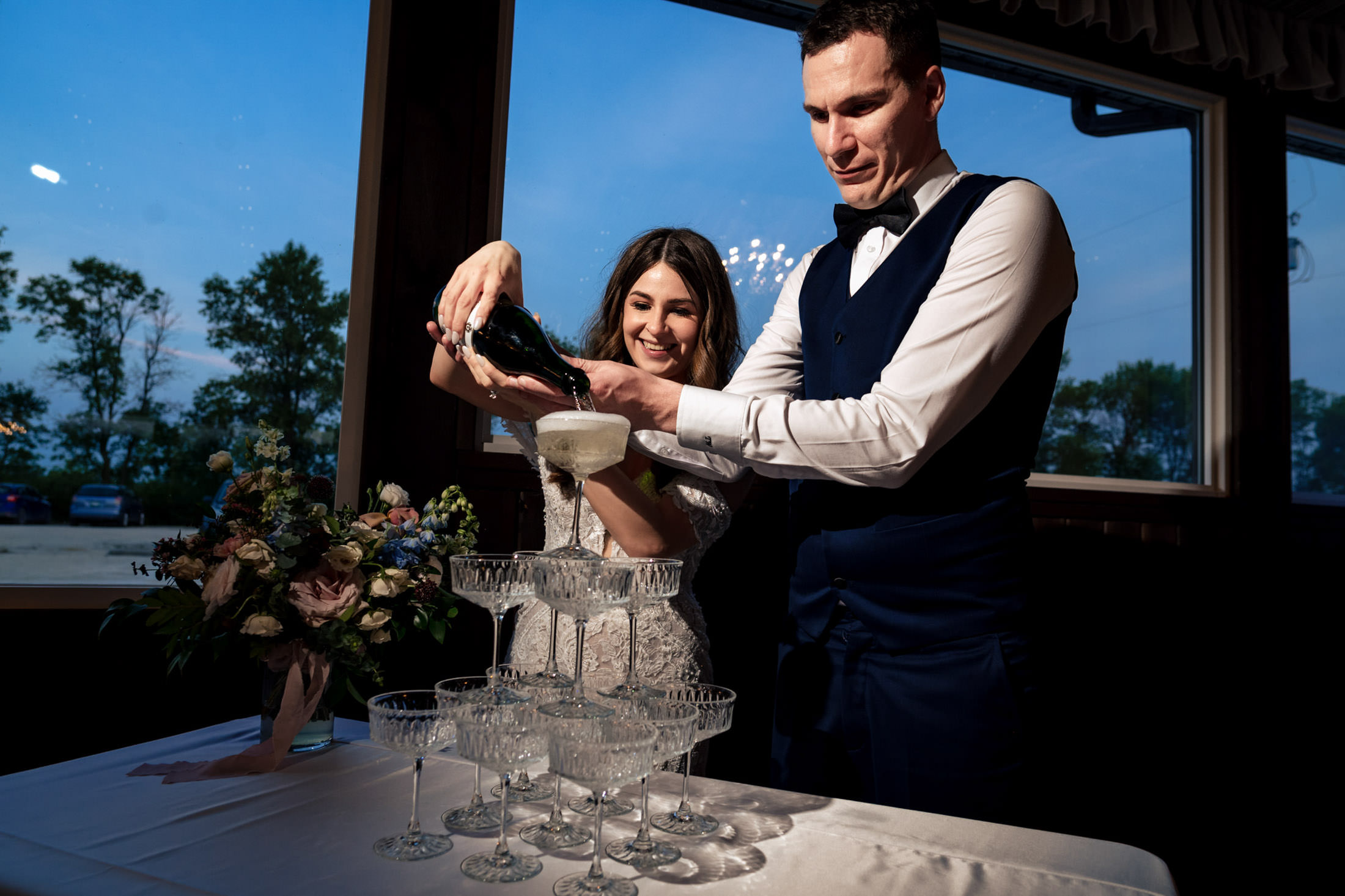 Couple pouring champagne at an Ashgrove Acres Wedding celebration.