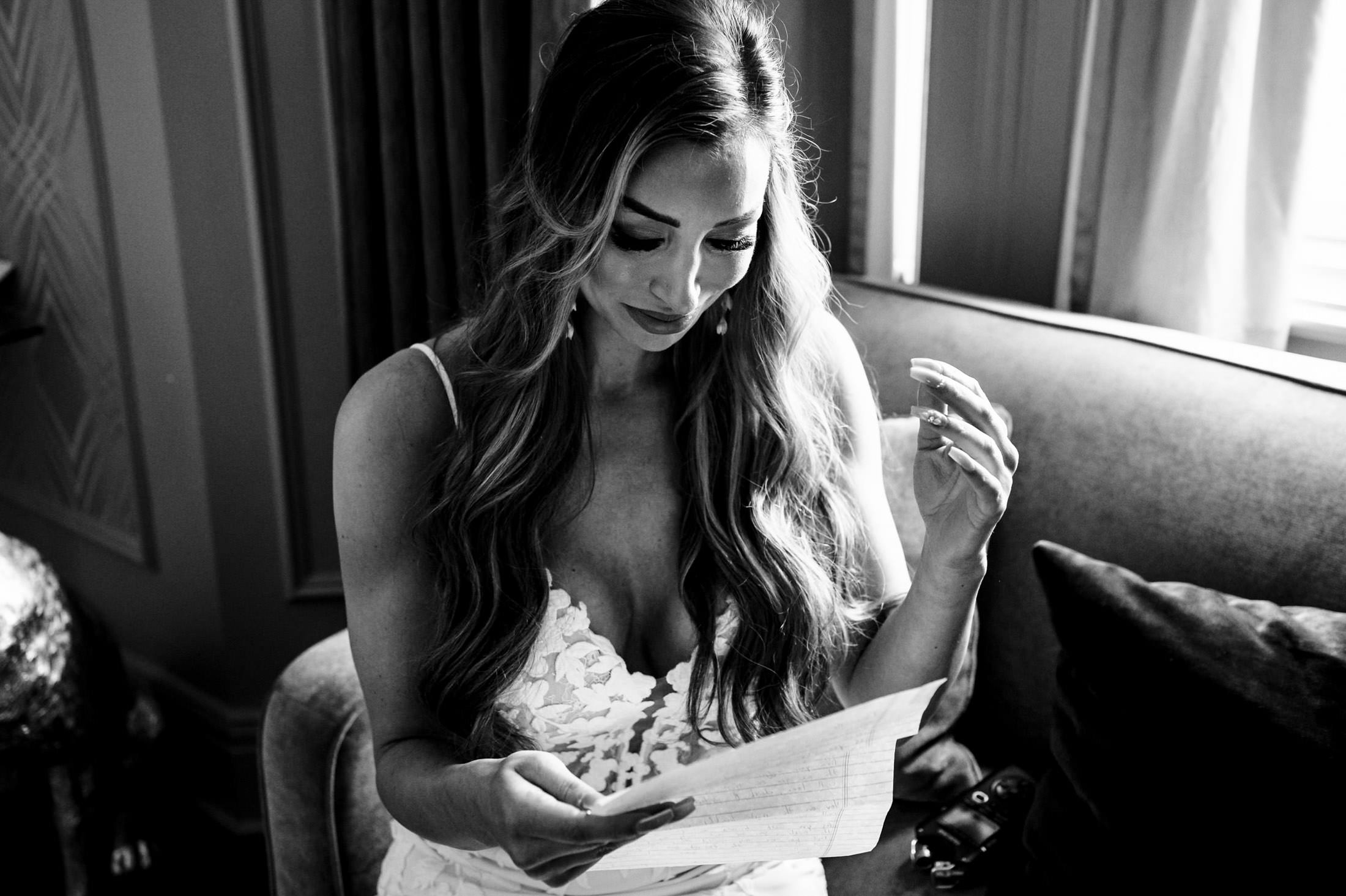 Bride reading a letter on the couch, reflecting on her Italian wedding in Winnipeg.