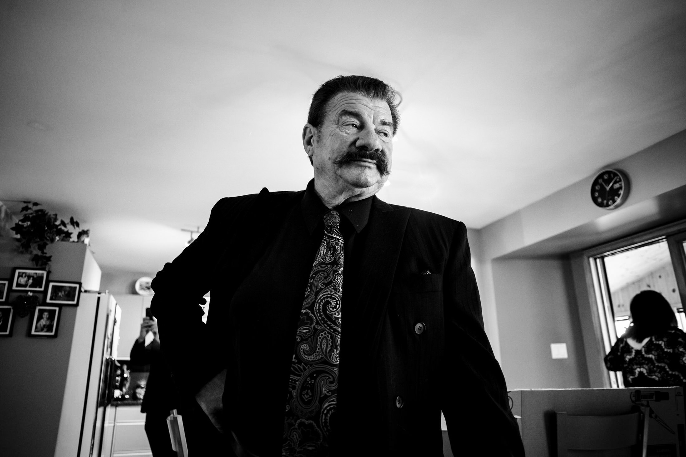 Man in a suit with a patterned tie stands at an Italian wedding in Winnipeg.