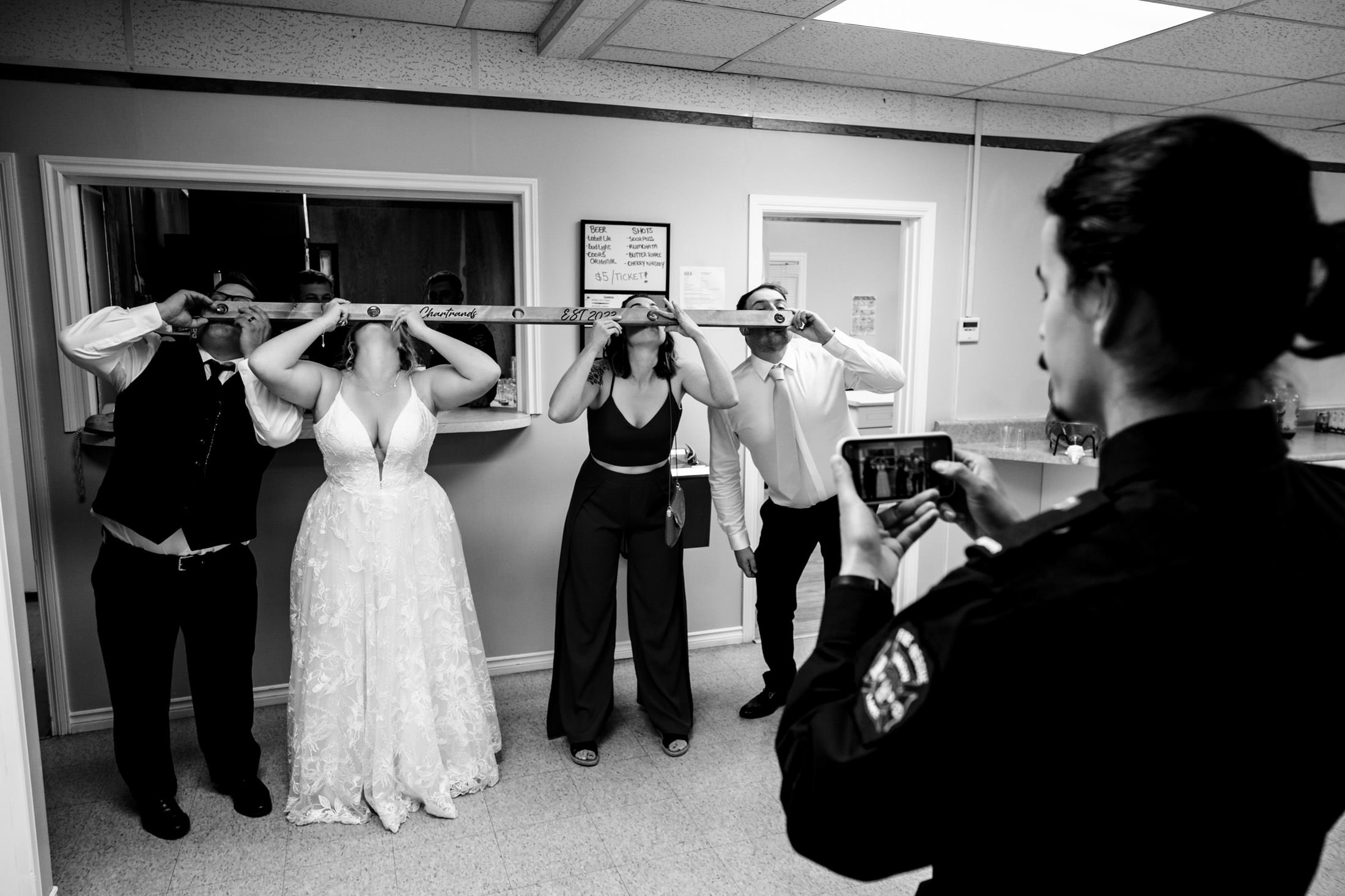 Wedding at Snow Lake: group shots with a woman capturing the moment on her phone.