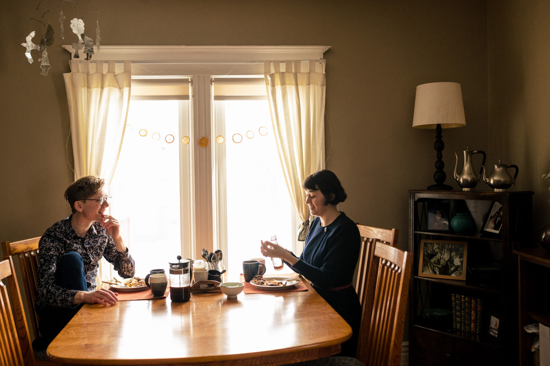 Two people enjoying a meal under the glow of Best Winnipeg Wedding Photos memories.