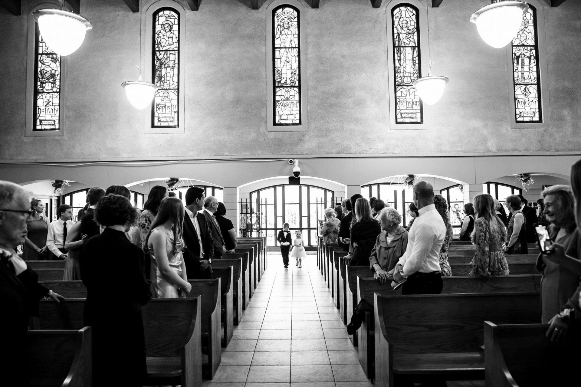 A child walks down a church aisle, an iconic shot in the best Winnipeg wedding photos.