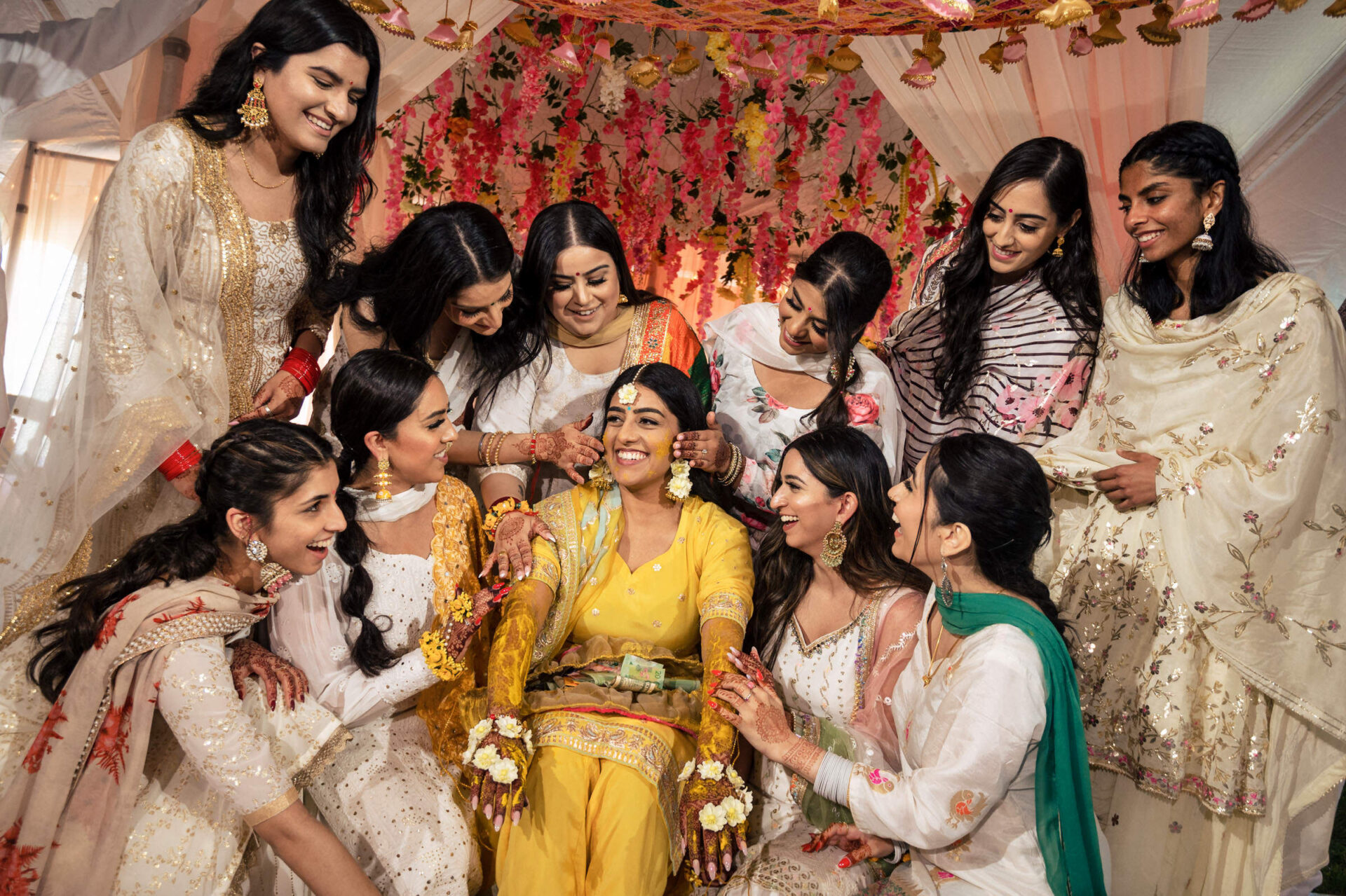 Women in colorful attire celebrate a joyful pre-wedding ceremony, capturing Winnipeg's best moments.