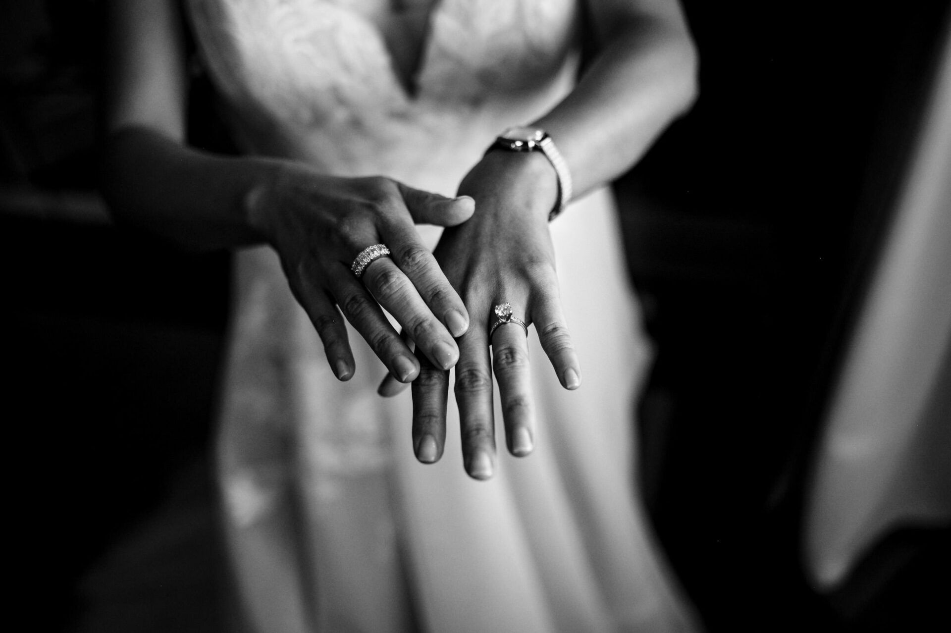 Bride proudly shows rings, in lace wedding dress, captured in best Winnipeg wedding photos.