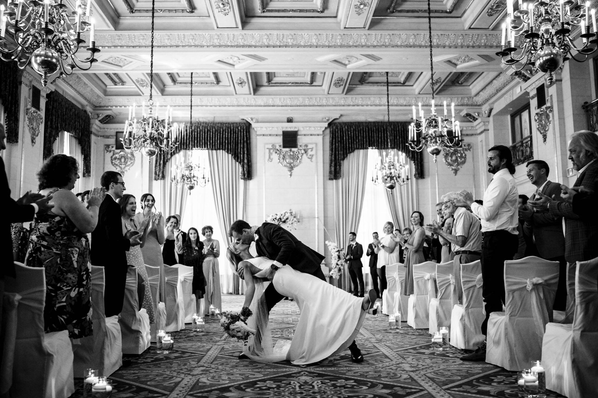 Bride and groom dance, captured in the best Winnipeg wedding photos, amid applause.