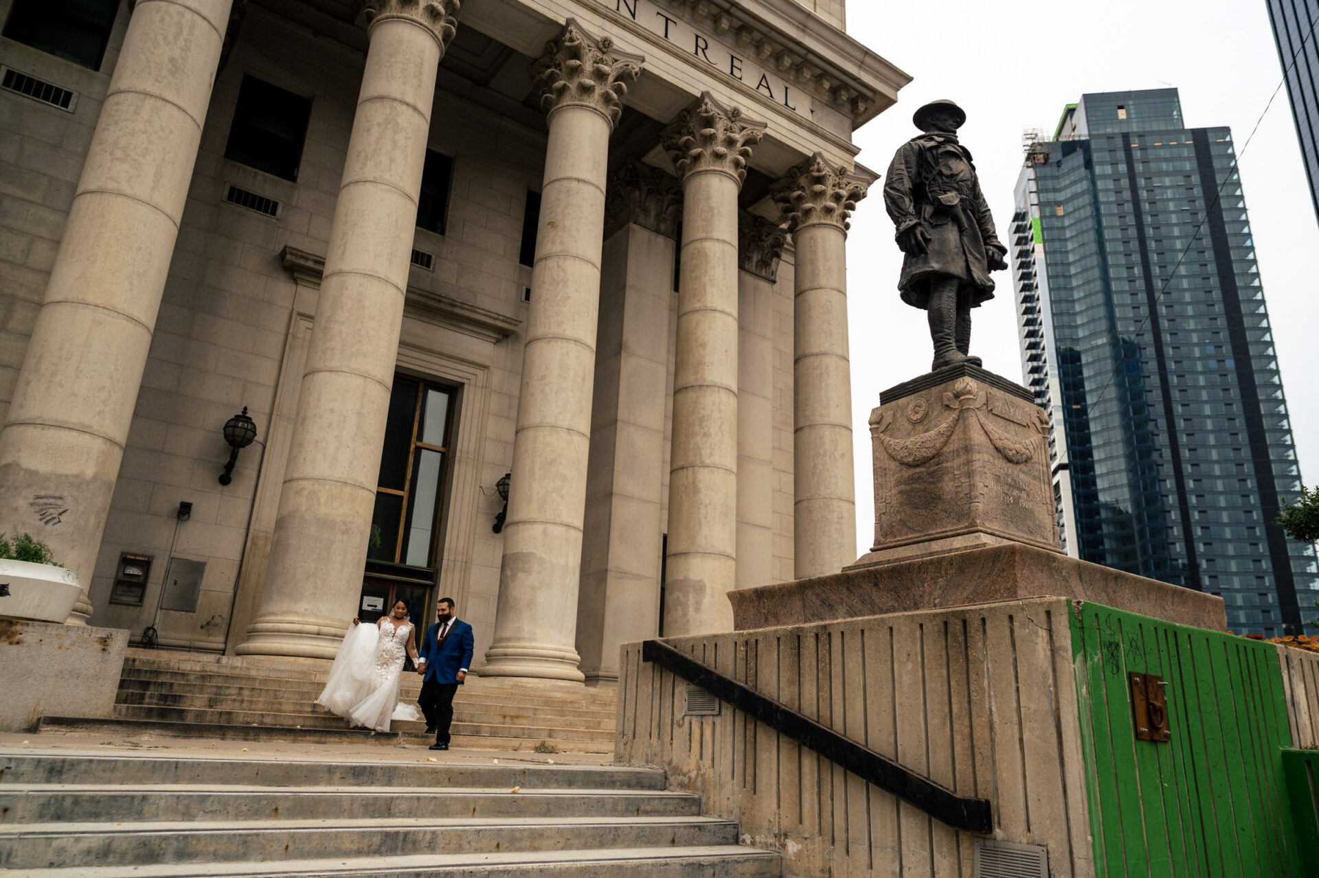 Bride and groom descend steps with skyline views; best Winnipeg wedding photos indeed.