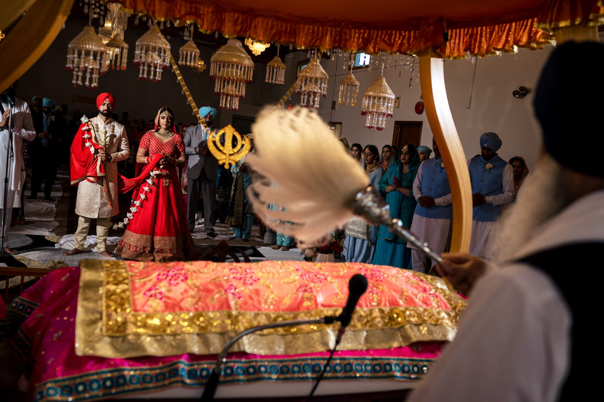 Best Winnipeg wedding photos capture a Sikh ceremony in a Gurdwara with traditional attire.