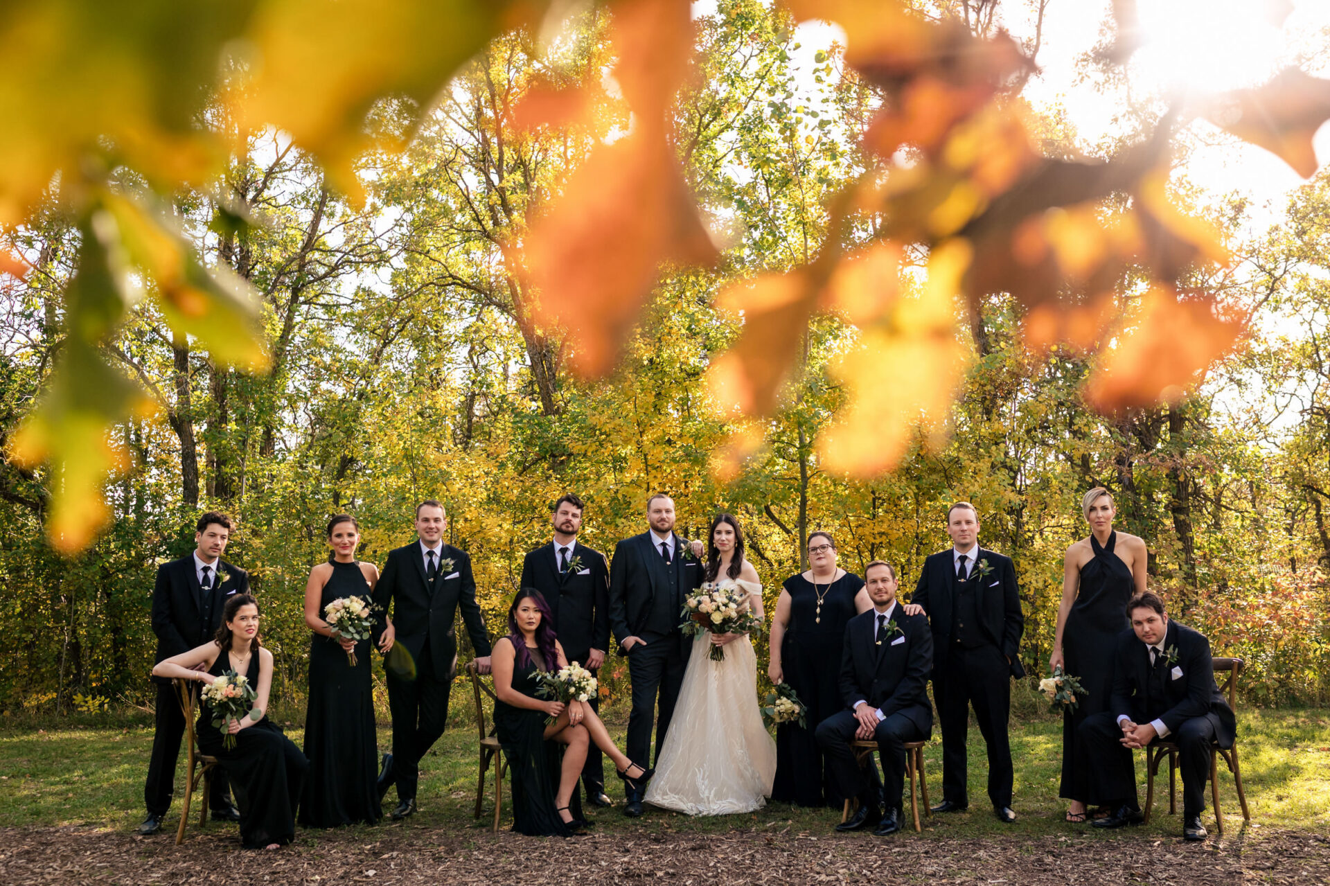 Best Winnipeg Wedding Photos capture love under autumn leaves outdoors.