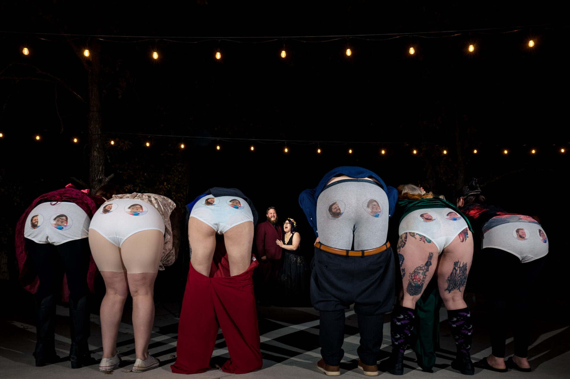 Best Winnipeg Wedding Photos: White undies with faces; black-clad couple in the background.