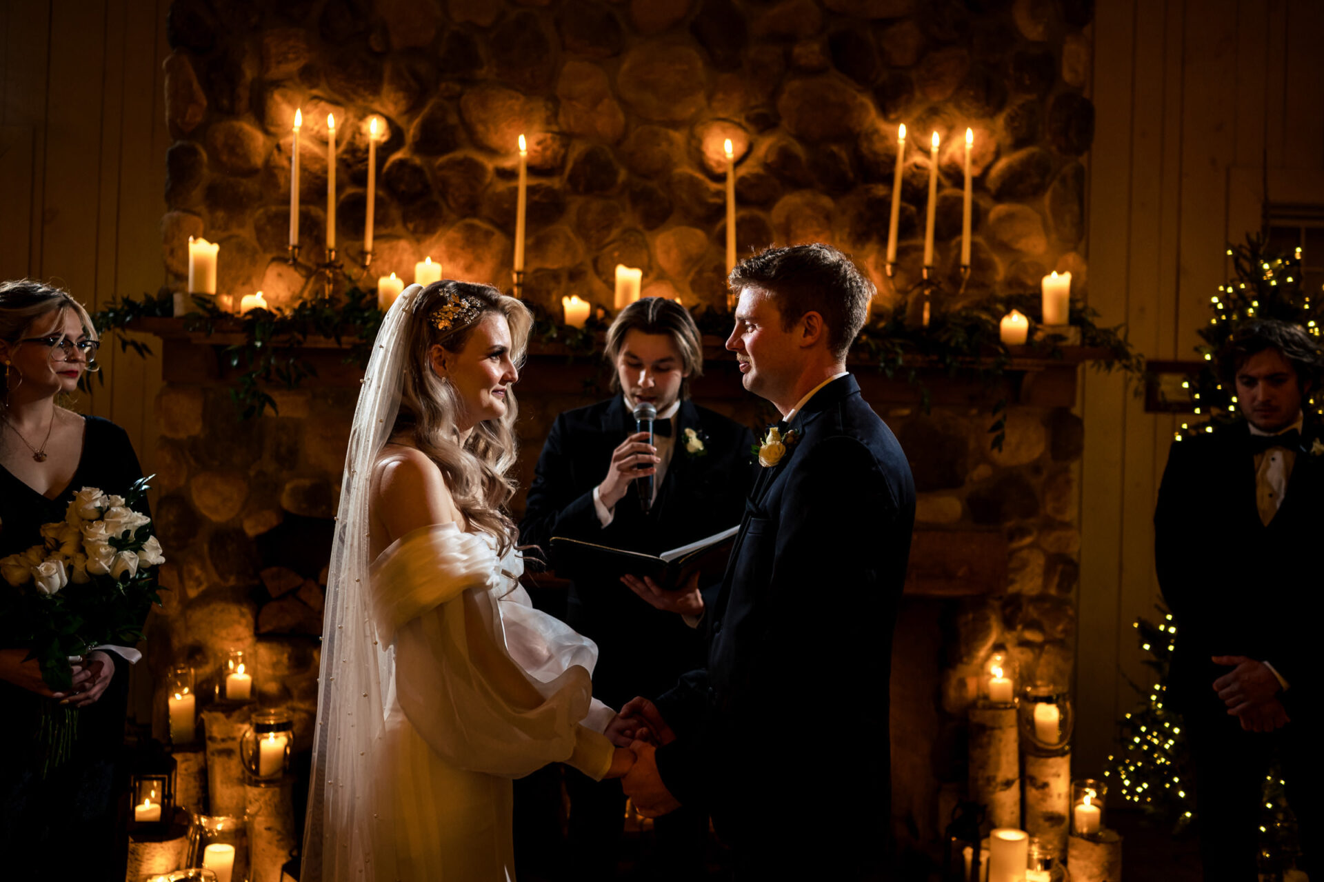 Bride and groom holding hands at a candlelit ceremony in the best Winnipeg wedding photo.