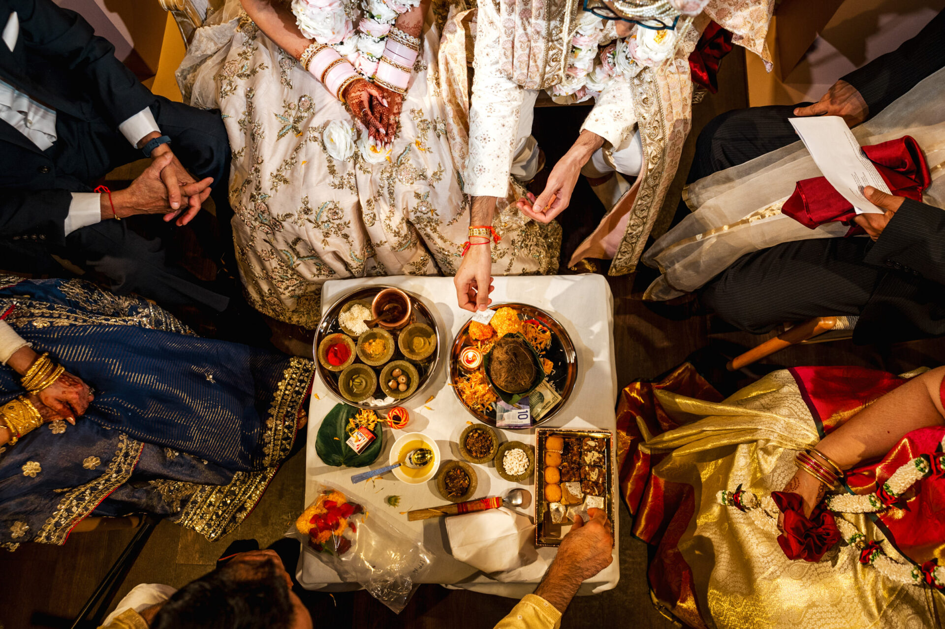 Traditional Indian ceremony like a Sikh or Hindu wedding with food and offerings on the table.